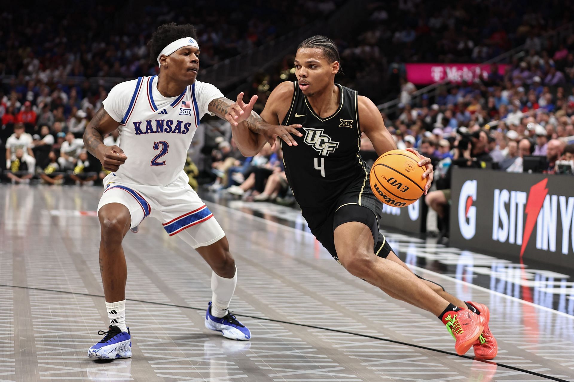 UCF Knights guard Keyshawn Hall (#4) drives past Kansas Jayhawks guard AJ Storr (#2) in the first half of their Big 12 tournament game on March 12, 2025 at T-Mobile Center in Kansas City, MO. Photo: Getty